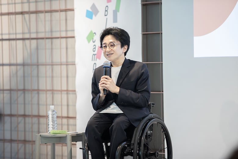 垣内が車いすに座り、参加者に語りかける様子
