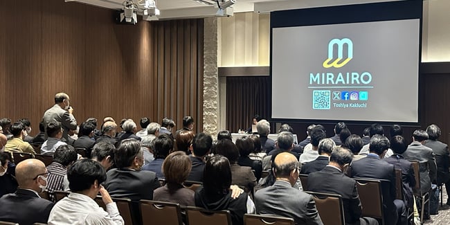 （写真）講演後に受講者がミライロ代表の垣内に質問をしている様子